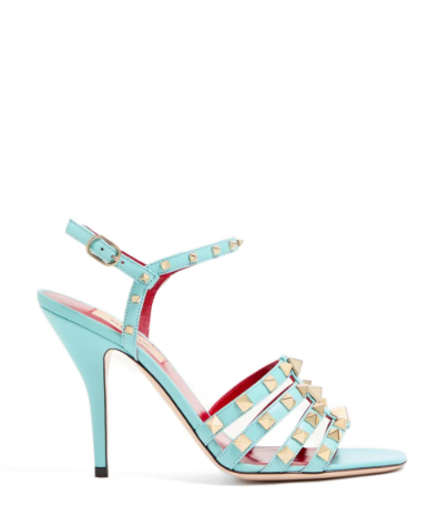 Premium azure blue kidskin leather sandals featuring platinum-finish studs in various sizes and an adjustable buckle strap for a bold yet elegant look.
